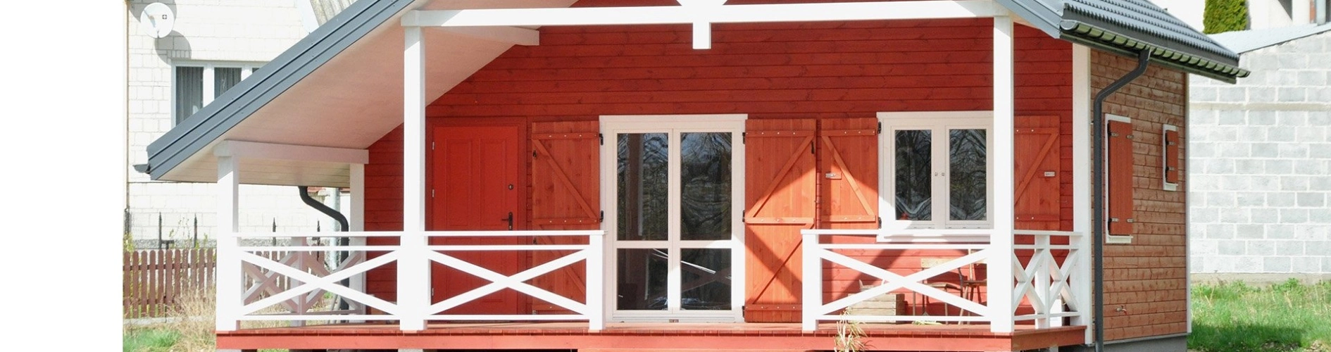 czerwony dom z drewna z białymi elementami